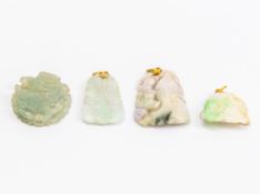 A GROUP OF FOUR CARVED JADE PENDANTS
