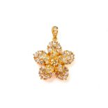 A COLOURED DIAMOND AND DIAMOND FLOWER SHAPED PENDANT