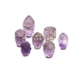 A GROUP OF LOOSE CARVED AMETHYST BUDDHA HEADS