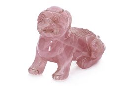 A CARVED ROSE QUARTZ MODEL OF A BUDDHIST LION