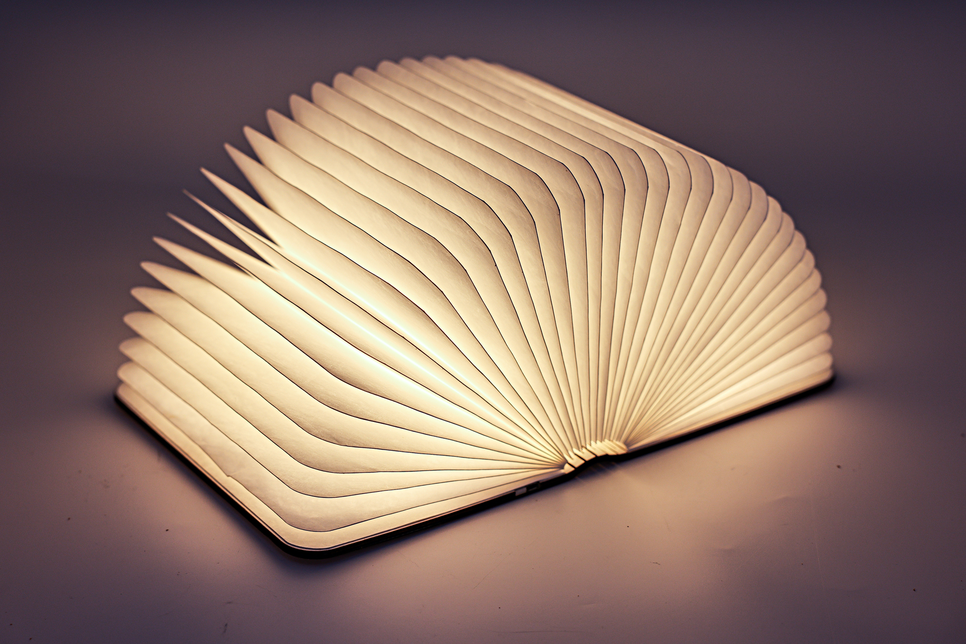 A LUMIO MULTI FUNCTIONAL PORTABLE BOOK FORM LAMP