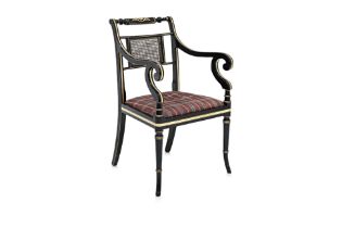 A REGENCY STLE EBONISED OPEN ARMCHAIR BY ARTHUR BRETT