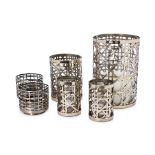 A GROUP OF SIX WOVEN METAL CANDLE HOLDERS