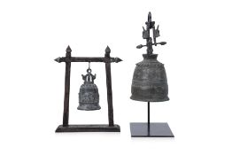 TWO SOUTHEAST ASIAN BRONZE BELLS ON STANDS