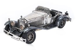 A SILVER MODEL OF A MERCEDES-BENZ CLASSIC CAR