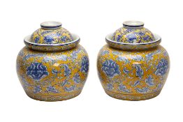 A PAIR OF LARGE YELLOW GROUND BLUE AND WHITE JARS AND COVERS