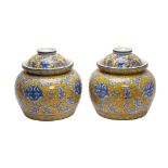 A PAIR OF LARGE YELLOW GROUND BLUE AND WHITE JARS AND COVERS