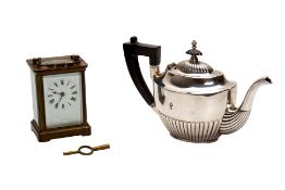 A BRASS FIVE GLASS CARRIAGE CLOCK AND A SILVER PLATED TEAPOT