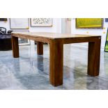 A LARGE TEAK DINING TABLE