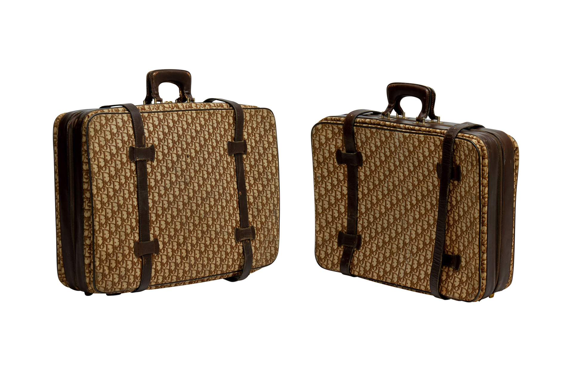 A GRADUATED SET OF TWO VINTAGE CHRISTIAN DIOR SUITCASES