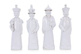 A SET OF FOUR WHITE PORCELAIN CHINESE DIGNITARIES