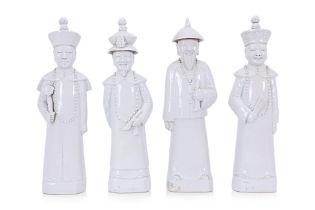 A SET OF FOUR WHITE PORCELAIN CHINESE DIGNITARIES