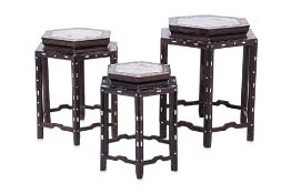 A GRADUATED SET OF THREE MARBLE INSET HEXAGONAL STANDS