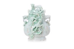 A CARVED JADE TWIN HANDLED VASE AND COVER