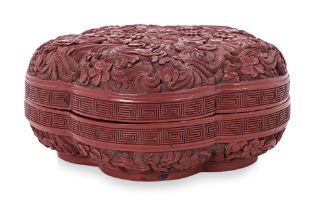A CARVED CINNABAR LACQUER PRUNUS BOX AND COVER