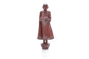 A BURMESE LACQUERED STANDING MONK