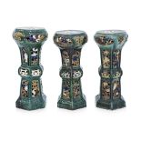 A GROUP OF THREE GLAZED POTTERY JARDINERE STANDS