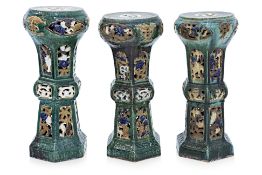 A GROUP OF THREE GLAZED POTTERY JARDINERE STANDS