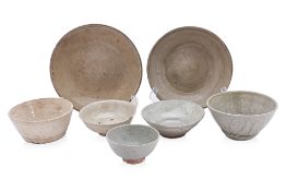 A GROUP OF SEVEN WHITE AND CELADON GLAZED BOWLS