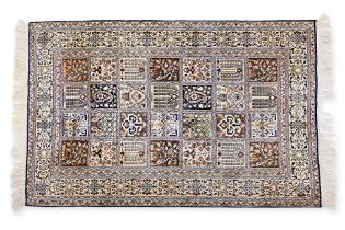 A SMALL SILK PANELLED RUG