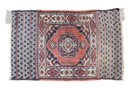 A SMALL MIDDLE EASTERN WOOL RUG