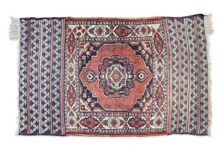 A SMALL MIDDLE EASTERN WOOL RUG