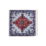 A SMALL SQUARE TIBETAN WOOL RUG