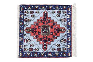 A SMALL SQUARE TIBETAN WOOL RUG