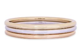 A SET OF THREE GOLD BANGLES BY TIFFANY & CO.