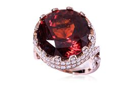A LARGE HESSONITE GARNET AND DIAMOND RING