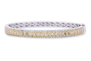 A YELLOW AND WHITE DIAMOND BANGLE