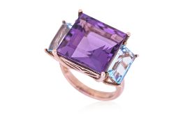 AN AMETHYST AND TOPAZ THREE STONE RING