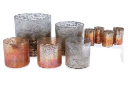 A GROUP OF NINE COLOURED GLASS CANDLE HOLDERS