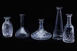 A GROUP OF FIVE WATERFORD, RIEDEL AND OTHER DECANTERS