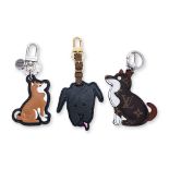 A LOUIS VUITTON SET OF THREE DOG BAG CHARMS