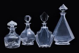 A GROUP OF FOUR VARIOUS GLASS DECANTERS