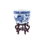 A BLUE AND WHITE JARDINIÈRE AND STAND