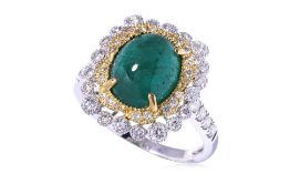 AN EMERALD CABOCHON AND DIAMOND RING