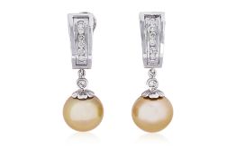 A PAIR OF CULTURED SOUTH SEA PEARL AND DIAMOND CLIP EARRINGS