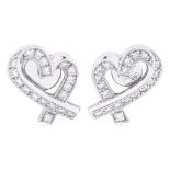 A PAIR OF 'RIBBON' DIAMOND STUD EARRINGS