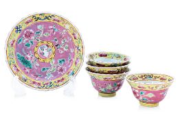 FOUR FAMILLE ROSE PINK GROUND TEA BOWLS AND A SAUCER