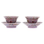 A PAIR OF PINK GROUND FAMILLE ROSE TEA BOWLS AND SAUCERS