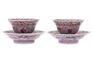 A PAIR OF PINK GROUND FAMILLE ROSE TEA BOWLS AND SAUCERS