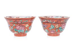 A PAIR OF CORAL GROUND FAMILLE ROSE TEA BOWLS
