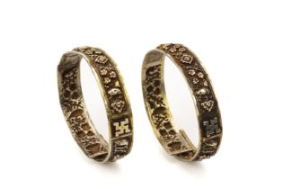 A PAIR OF REPOUSSE SILVER BANGLES