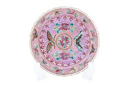A PINK GROUND FAMILLE ROSE 'BUTTERFLY' SAUCER