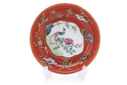 A CORAL RED GROUND FAMILLE ROSE SAUCER