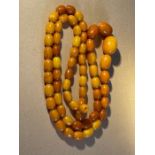 Vintage String of Butterscotch Amber/Bakelite Beads - 88cm (35") long - 62 grams.