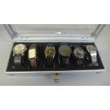 Six wristwatches in a case, including Swatch and Timex
