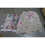 A silk and embroidered shawl and a mat
